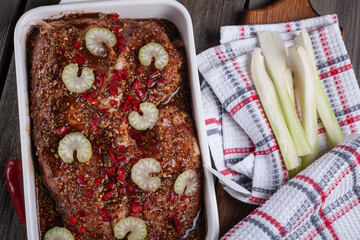 Meat cut into Pieces and being prepared with spices and celery ready for cooking