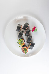 Black suhi rolls on white background