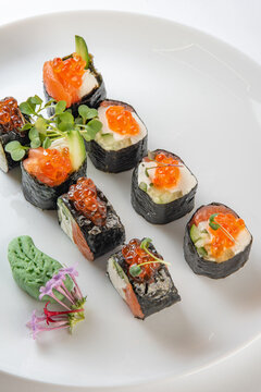 sushi rolls with avocado, salmon and vasabi