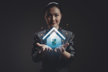 Asian woman happy showing with home icon hologram effect.