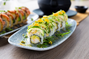 Sushi. Green sushi with avocado and prawn. Appetizing Japanese cuisine served in the restaurant