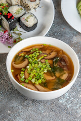 soup with meatballs and sushi rolls