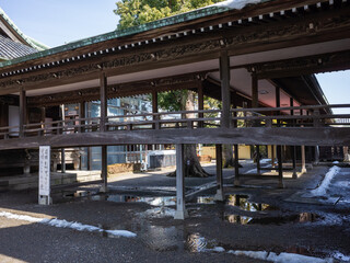 wooden path of taishakuten temple and wet ground