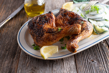 Low carb chicken dish with cucumber salad on plate