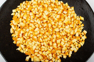Raw Chopped Orange Peel, Zest on Black Plate