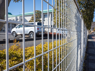 white iron fence of the parking lot
