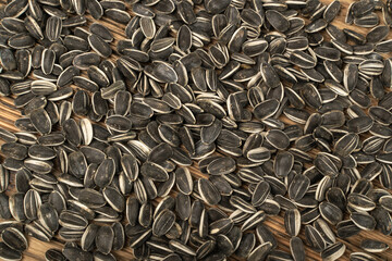 Sunflower Seeds, Striped Raw Seeds on Wood Background Texture Top View