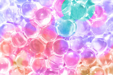 Relief texture of glass Christmas ball made of small glass balls colored in neon colors close up.