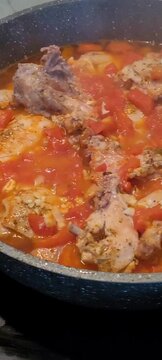 Chakhokhbili in a brazier. The process of frying the national Georgian dish. Pan fried chicken with vegetables.