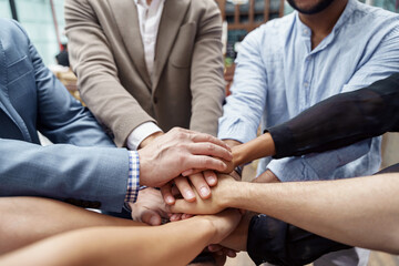 Top view of group multi ethnic coworkers stacked hands together as concept of corporate unity