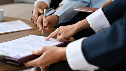 A businessman sign his signature on a contract agreement paper
