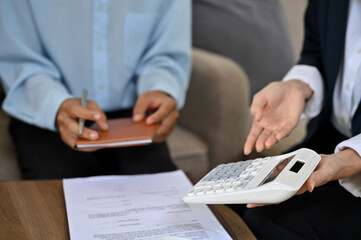 Talented female real estate agent or realtor meets with her client to finalize the deal