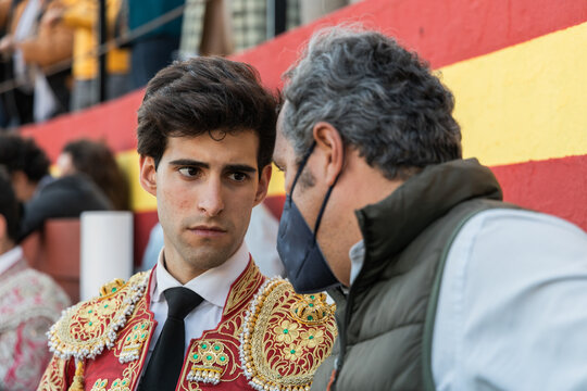 Young matadore speaking with trainer