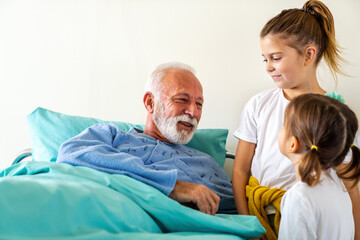 Fototapeta premium Happy grandfather is recovering from the coronavirus is visited by his grandchildren