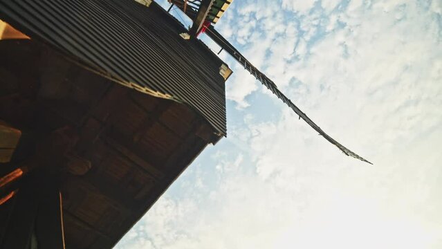 POV shot of a person walking past an old windmill in the historic fortified town of Heusden, Noord-Brabant, by morning.