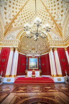 St. Petersburg, Russia - May 27, 2021: Hermitage Museum, Throne Room of the Palace. A red throne on a pedestal. Рalace interior details.