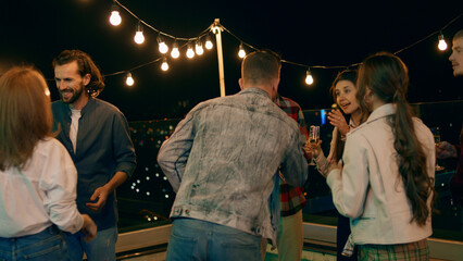 Multiracial people have a party time on the rooftop of terrace they dancing and feeling excited enjoy the time together