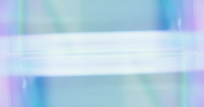 Neon light motion. Geometric abstract background. Blur iridescent blue pink color LED glow presentation empty space for text. Seamless loop rotation. Shot on RED Cinema camera.