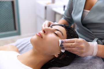 Young beautiful girl during cosmetic procedures in the beautician's office. Spa, beauty, wellness,...