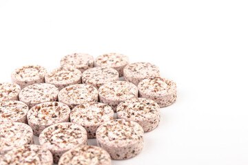 Heap of medicine colored pills, tablets on a white background