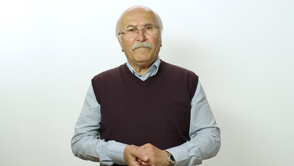 Loving old man looking at camera. Studio portrait of old man isolated on white background. Portrait of a thoughtless smiling neutral old man.