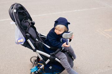 Obraz premium toddler blond baby boy in a pram