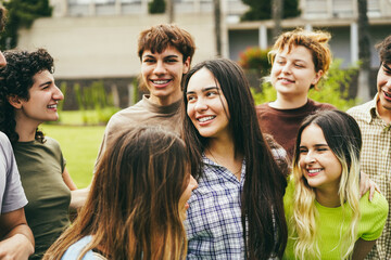 Young group of friends having fun outdoor with university on background - Focus on center girl face