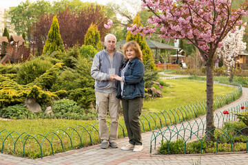 Mature elderly couple in summer park, senior couple relax in spring summer or autumn time. Healthcare lifestyle elderly retirement love couple together valentines day concept