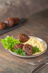 Healthy lunch - chicken liver maffins with salad and couscous on the table