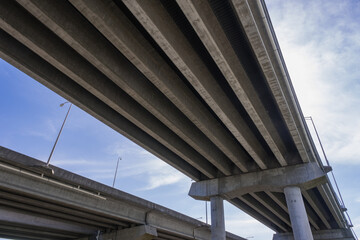 View Underneath a Large Bridge Highway on a Sunny Day with Blue Sky