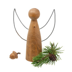 Turned wooden angel figure decorated with pine cones and pine needles isolated on white