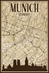 Black printout streets network map with city skyline of the downtown MUNICH, GERMANY on a vintage paper framed background