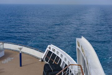 View from open outdoor deck of legendary luxury ocean liner cruise ship on passage during...