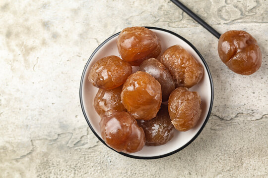 Chestnut candied sugar syrup and glazed or marron glacé,  confection, originating in northern Italy and southern France. Directly above, copy space.