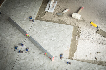 Laying floor ceramic tile. Tools for renovating floor