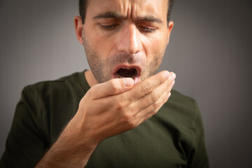 Man checks his breath with his hand. The concept of halitosis - obrazy, fototapety, plakaty
