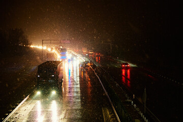 Car accident on slippery road at night during snowfall, Dangerous driving during winter snowstorm