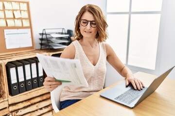 Middle age hispanic woman smiling confident working at office