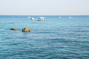 Fototapeta premium Seascape with boats anchored offshore in a sunny day. Sicily, Italy.