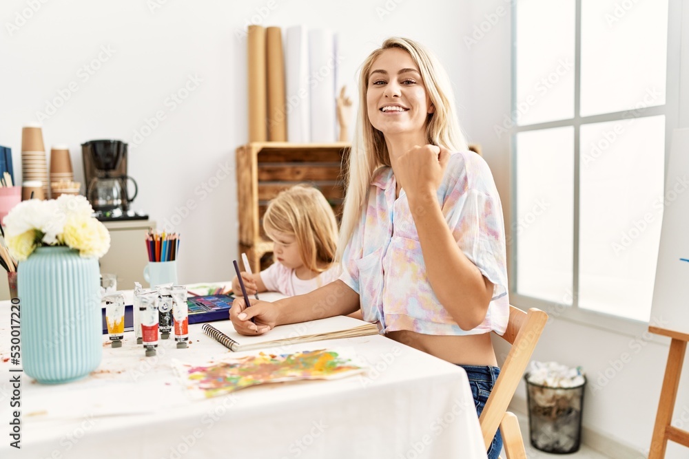 Sticker Caucasian family of mother and daughter painting at art studio screaming proud, celebrating victory and success very excited with raised arms