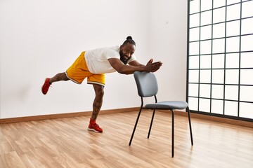 Fototapeta premium Young african american man smiling confident training at sport center