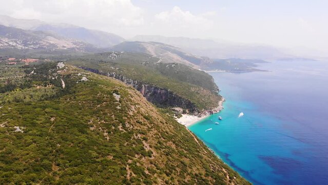 Aerial Drone View of Gjipe Beach and Canyon, Dhermi, Albania - Hidden Paraside with boats, tourists, sunbeds and blue sea