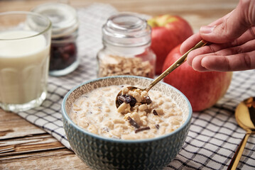 Granola with milk in blue bowl on wooden table, Healthy organic breakfast with muesli, Food clean eating concept