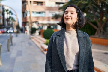Young woman smiling confident breathing at park