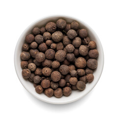 Dry allspice pepper in round bowl isolated on white. Top view.