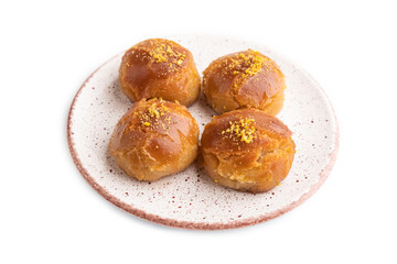 Traditional turkish dessert sekerpare with almonds and honey isolated on white, side view.