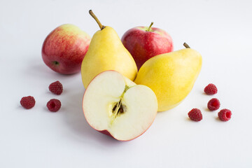 Close-up on pear, apple and raspberry on the white background
