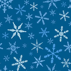 seamless pattern of various snowflakes on a blue background