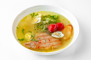 Fragrant first coursefrom chicken broth, quail eggs and poultry meat. Dietary cream soup based on baked and fresh vegetables with herbs. Fitness menu. Delivery of prepared food. White backgr