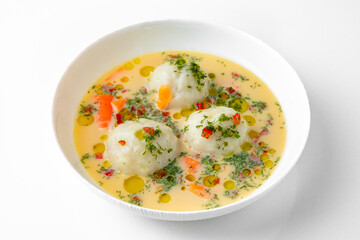 Fragrant first course with chicken broth, cream and meatballs. Dietary cream soup based on baked and fresh vegetables with herbs. Fitness menu. Delivery of prepared food. White background